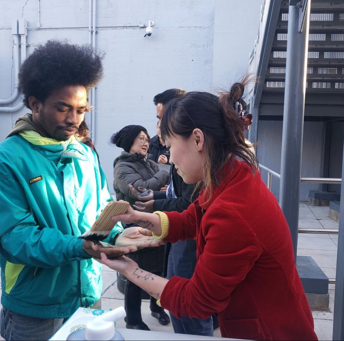 Painting the hands of vigil attendees